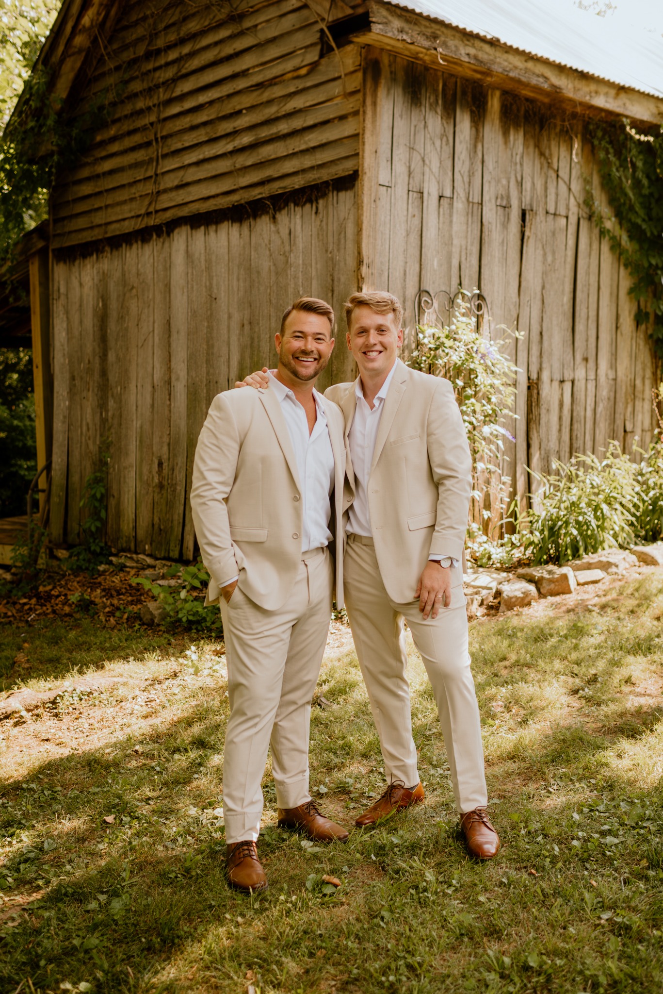 A wedding portrait beside a rustic barn