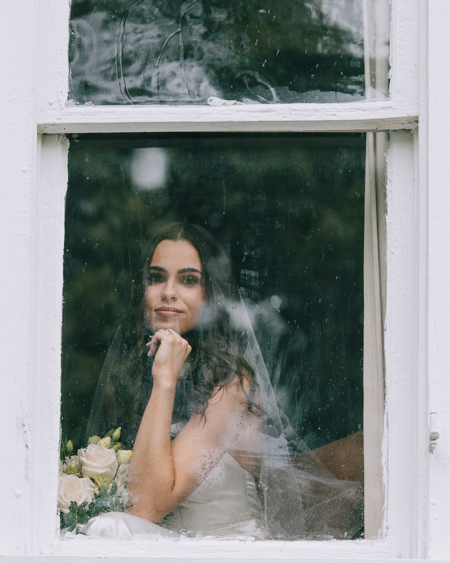 A bridal portrait through a historic estate window